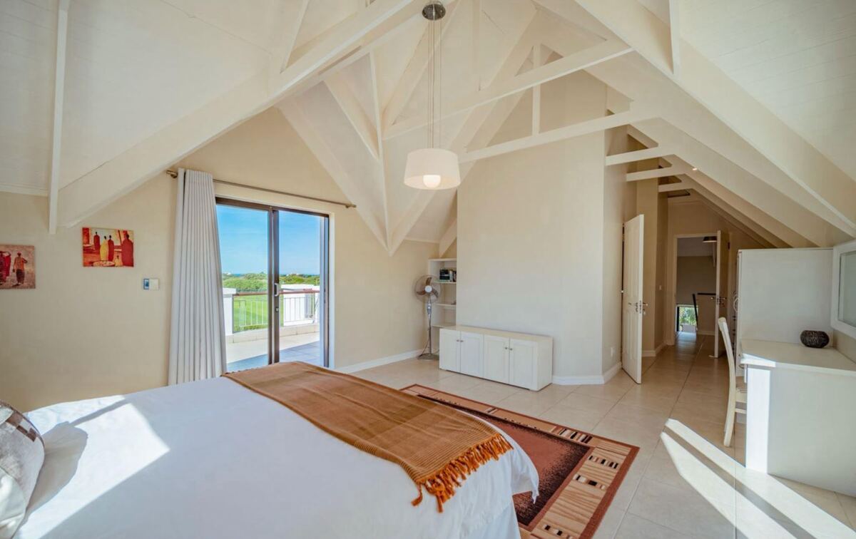 Ground-floor bedroom made up as a king, opening onto the veranda