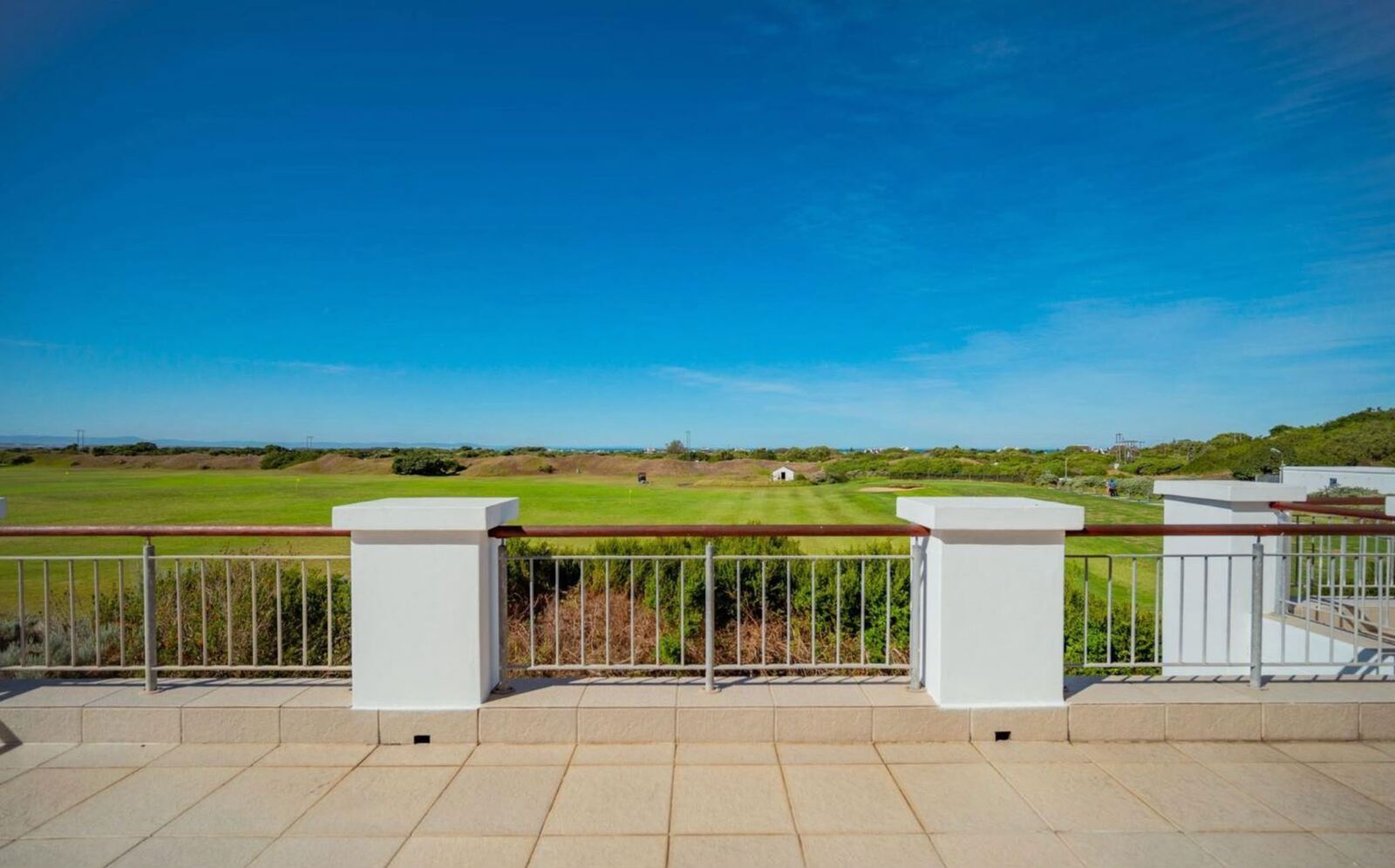 View from Wildehaven's terrace across the driving range to the dunes